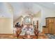 Spacious great room boasts cathedral ceilings, large window, and ample space for dining and recreation at 222 Stony Ln, Noblesville, IN 46060