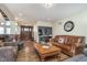 Inviting living room featuring hardwood floors, a comfortable leather sofa and stylish decor at 222 Stony Ln, Noblesville, IN 46060