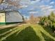 Exterior view of a barn with fresh paint, surrounded by a well-maintained lawn and partial fencing at 2275 N 250 E, Lebanon, IN 46052