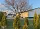 Exterior view of the home, surrounded by green trees and a large garage/storage building at 2275 N 250 E, Lebanon, IN 46052