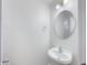 Neat powder room features a sink with a round mirror and modern lighting at 2632 Frasier Fir Dr, Greenwood, IN 46143