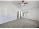 Bright carpeted bedroom featuring vaulted ceilings, ceiling fan, and large windows at 2632 Frasier Fir Dr, Greenwood, IN 46143