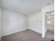 A carpeted bedroom space with light-colored walls and an ample closet at 2632 Frasier Fir Dr, Greenwood, IN 46143
