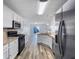 Modern kitchen featuring stainless steel appliances, white cabinets and hardwood floors at 2632 Frasier Fir Dr, Greenwood, IN 46143