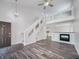 Open concept living room with a modern staircase, fireplace, and neutral paint at 2632 Frasier Fir Dr, Greenwood, IN 46143
