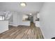Open-concept living room and kitchen featuring modern wood-look flooring and neutral paint at 2632 Frasier Fir Dr, Greenwood, IN 46143