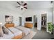 Spacious main bedroom featuring a ceiling fan, large bed, and ensuite bathroom at 2632 Frasier Fir Dr, Greenwood, IN 46143