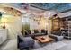 Relaxing basement living area with comfortable seating, colorful pillows, and decorative ceiling at 304 W 43Rd St, Indianapolis, IN 46208