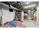 Unfinished basement with exercise equipment, water heater, and exposed ductwork at 304 W 43Rd St, Indianapolis, IN 46208