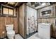 Basement bathroom featuring rustic wood paneling, a shower with a floral curtain, and a vanity at 304 W 43Rd St, Indianapolis, IN 46208