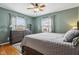 Cozy bedroom featuring a ceiling fan, dresser, and soft natural light from the windows at 304 W 43Rd St, Indianapolis, IN 46208