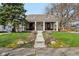 Charming single-story home featuring a welcoming front porch with red doors at 304 W 43Rd St, Indianapolis, IN 46208