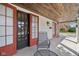 Spacious covered front porch with tiled flooring, outdoor seating, and wood ceiling at 304 W 43Rd St, Indianapolis, IN 46208