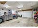 Well-lit garage featuring a vintage truck project, a roll-up door, and ample workspace at 304 W 43Rd St, Indianapolis, IN 46208
