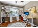 Home office with custom shelving, hardwood floors, large window and a wood desk at 304 W 43Rd St, Indianapolis, IN 46208