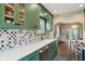 Kitchen with green cabinets, stainless appliances, quartz counters, and view into the dining room at 304 W 43Rd St, Indianapolis, IN 46208
