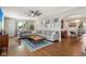 Bright living room featuring a large sectional, hardwood floors, and ceiling fan at 304 W 43Rd St, Indianapolis, IN 46208