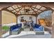 Covered outdoor lounge area with comfortable seating, ceiling fan, and decorative lighting at 304 W 43Rd St, Indianapolis, IN 46208