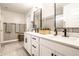 Bright bathroom with double vanity, white cabinets, modern fixtures, and stylish mirrors at 3164 Kent Dr, Brownsburg, IN 46112