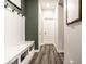 Inviting entryway with built-in bench, coat hooks, and stylish flooring for organized functionality at 3164 Kent Dr, Brownsburg, IN 46112