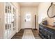 Elegant entryway featuring wood floors, stylish furniture, and a bright white front door at 3164 Kent Dr, Brownsburg, IN 46112