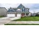 Beautiful blue two-story home featuring a three-car garage and a well-manicured front lawn at 3164 Kent Dr, Brownsburg, IN 46112