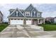 Inviting blue two-story home featuring a three-car garage and well-maintained landscaping at 3164 Kent Dr, Brownsburg, IN 46112