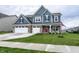 Charming two-story home with a three-car garage and a well-manicured front yard at 3164 Kent Dr, Brownsburg, IN 46112