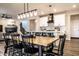 Open concept kitchen and dining area with modern lighting, white cabinets, and a wooden dining table at 3164 Kent Dr, Brownsburg, IN 46112