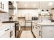 Modern kitchen with white cabinets, stainless steel appliances, a stylish backsplash, and a patterned rug at 3164 Kent Dr, Brownsburg, IN 46112