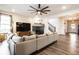 Comfortable living room featuring a modern fireplace, large sofa, and staircase at 3164 Kent Dr, Brownsburg, IN 46112