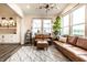 Stylish living room features a leather sofa, modern lighting, large windows, and an open floor plan at 3164 Kent Dr, Brownsburg, IN 46112