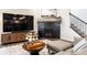 Living room with modern fireplace, TV, and view of stairs and kitchen at 3164 Kent Dr, Brownsburg, IN 46112