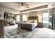 Spacious main bedroom featuring tray ceiling, neutral tones, large windows, and sitting area at 3164 Kent Dr, Brownsburg, IN 46112