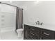 Bathroom featuring a vanity, tub with tile surround, and modern fixtures at 324 W 7Th St, Anderson, IN 46016