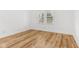 Bright bedroom with hardwood floors and a window overlooking the exterior at 324 W 7Th St, Anderson, IN 46016