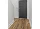 Modern entryway with dark door, and light wood-look floors provides a clean and stylish transition into the home at 324 W 7Th St, Anderson, IN 46016