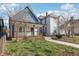 Charming blue two-story home with front porch surrounded by a green lawn at 324 W 7Th St, Anderson, IN 46016