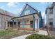 Close-up of a charming blue two-story home featuring a spacious, covered front porch at 324 W 7Th St, Anderson, IN 46016