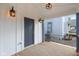 Covered front porch with stylish lighting fixtures illuminating the front door at 324 W 7Th St, Anderson, IN 46016