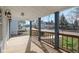 Spacious covered front porch with wood flooring, stylish lighting, and blue support columns at 324 W 7Th St, Anderson, IN 46016