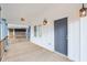 Spacious covered front porch featuring wood flooring, stylish lighting, and white support columns at 324 W 7Th St, Anderson, IN 46016