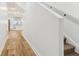 Bright hallway showcasing light floors, white walls, and a glimpse into the modern kitchen area at 324 W 7Th St, Anderson, IN 46016