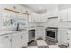 Bright kitchen with white cabinetry, marble countertops, and stainless steel appliances at 324 W 7Th St, Anderson, IN 46016