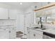 Bright kitchen with white cabinetry, marble countertops, and stainless steel appliances at 324 W 7Th St, Anderson, IN 46016