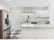 Bright kitchen with white cabinetry, stainless steel appliances, and a unique tile floor design at 324 W 7Th St, Anderson, IN 46016
