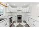 Well-lit kitchen featuring white cabinets, marble countertops, and stainless steel appliances at 324 W 7Th St, Anderson, IN 46016