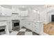 Well-lit kitchen featuring white cabinets, marble countertops, and stainless steel appliances at 324 W 7Th St, Anderson, IN 46016
