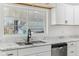 Bright kitchen with white cabinetry, marble countertops, and stainless steel appliances at 324 W 7Th St, Anderson, IN 46016