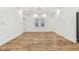 Bright, open-concept living room with wood floors and tray ceiling offers lots of natural light at 324 W 7Th St, Anderson, IN 46016